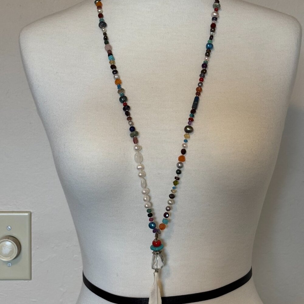 Long multi gem bead necklace with carved feather pendant
